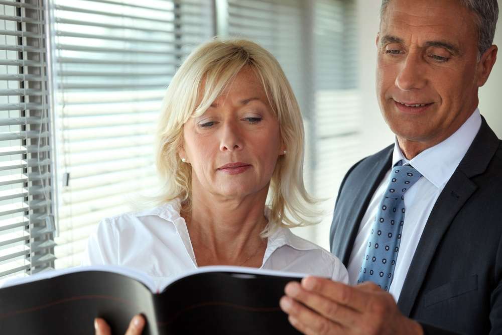 Worried company directors discussing a director disqualification investigation
